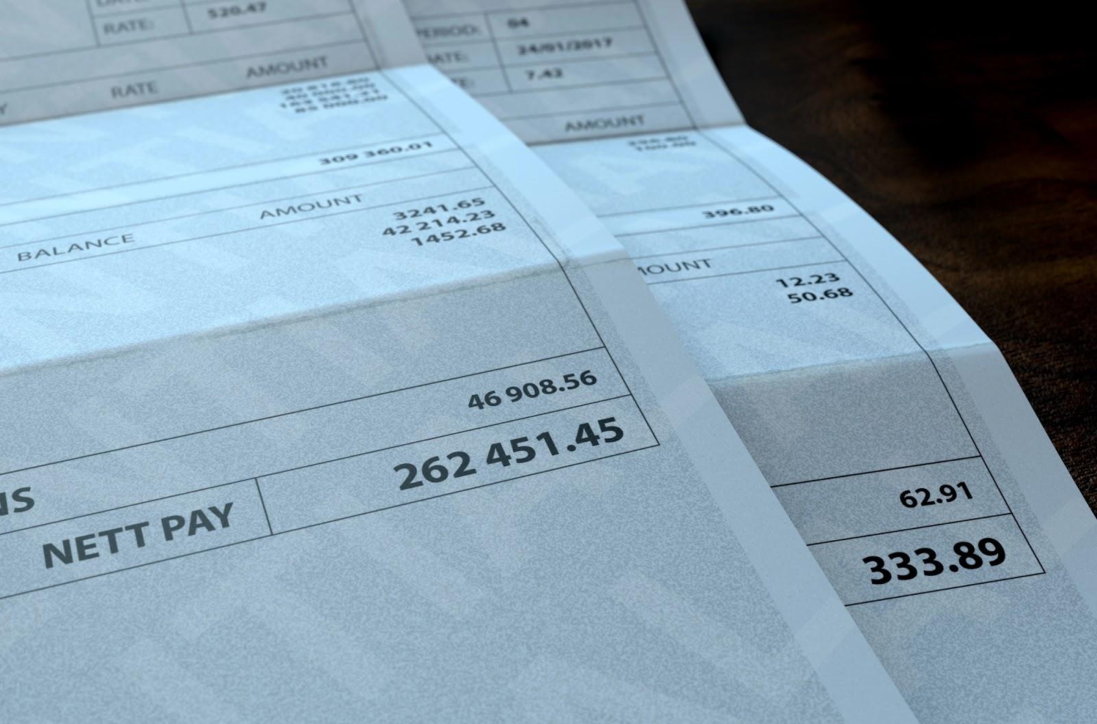 Two paychecks with very different payment amounts, showing the difference between pay for exempt vs. non-exempt employees.